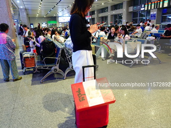 A large number of passengers prepare to travel at Yichang East Railway Station during the Mid-Autumn Festival holiday in Yichang, China, on...