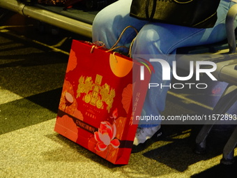 A large number of passengers prepare to travel at Yichang East Railway Station during the Mid-Autumn Festival holiday in Yichang, China, on...