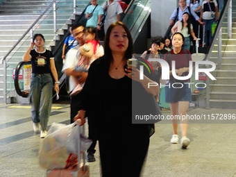 A large number of passengers prepare to travel at Yichang East Railway Station during the Mid-Autumn Festival holiday in Yichang, China, on...