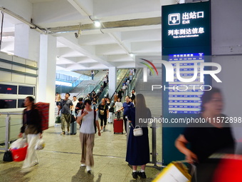 A large number of passengers prepare to travel at Yichang East Railway Station during the Mid-Autumn Festival holiday in Yichang, China, on...