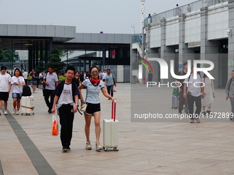 A large number of passengers prepare to travel at Yichang East Railway Station during the Mid-Autumn Festival holiday in Yichang, China, on...