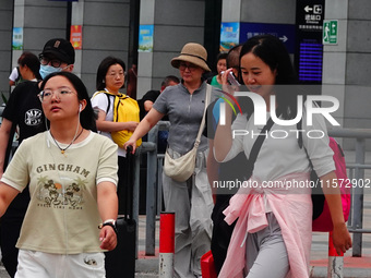 A large number of passengers prepare to travel at Yichang East Railway Station during the Mid-Autumn Festival holiday in Yichang, China, on...