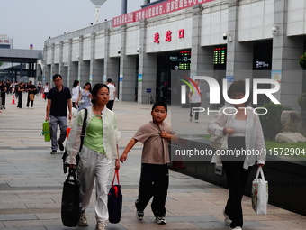 A large number of passengers prepare to travel at Yichang East Railway Station during the Mid-Autumn Festival holiday in Yichang, China, on...