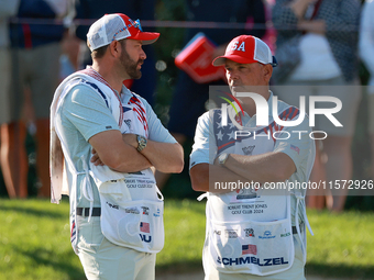 GAINESVILLE, VIRGINIA - SEPTEMBER 14: The caddies for Sarah Schmelzel of the United States (R) and Lilia Vu of of Team USA (L) wait on the 7...