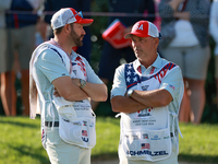 GAINESVILLE, VIRGINIA - SEPTEMBER 14: The caddies for Sarah Schmelzel of the United States (R) and Lilia Vu of of Team USA (L) wait on the 7...