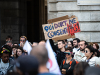 A protestor holds a placard reading ''who sleeps does not consent'' during a demonstration in support of Gisele Pelicot in Rennes, France, o...