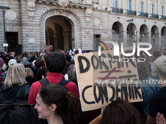 A protestor holds a placard reading ''sleep on the contrary to consent'' during a demonstration in support of Gisele Pelicot in Rennes, Fran...