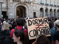 A protestor holds a placard reading ''sleep on the contrary to consent'' during a demonstration in support of Gisele Pelicot in Rennes, Fran...