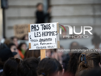 A protestor holds a placard reading ''not all men but always one man, educate yourself'' during a demonstration in support of Gisele Pelicot...