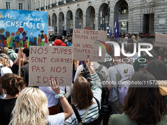 Two protestors hold a placard reading (L) ''our skirts are short, not our ideas'' and (R) ''a metro every 2 minutes, a rape every 7 minutes'...