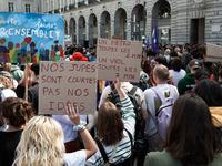 Two protestors hold a placard reading (L) ''our skirts are short, not our ideas'' and (R) ''a metro every 2 minutes, a rape every 7 minutes'...