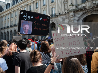 A protestor holds a placard reading ''our skirts are short, not our ideas'' during a demonstration in support of Gisele Pelicot in Rennes, F...