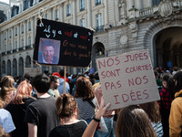 A protestor holds a placard reading ''our skirts are short, not our ideas'' during a demonstration in support of Gisele Pelicot in Rennes, F...