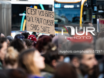 A protestor holds a placard reading ''it's your dicks that need to be filed away'' during a demonstration in support of Gisele Pelicot in Re...