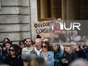 A protestor holds a placard reading ''who sleeps does not consent'' during a demonstration in support of Gisele Pelicot in Rennes, France, o...