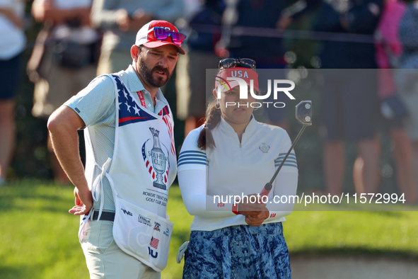 GAINESVILLE, VIRGINIA - SEPTEMBER 14: Lilia Vu of Team USA lines up her putt with her caddie on the 7th green during Day Two of the Solheim...