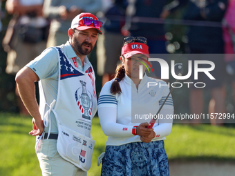 GAINESVILLE, VIRGINIA - SEPTEMBER 14: Lilia Vu of Team USA lines up her putt with her caddie on the 7th green during Day Two of the Solheim...