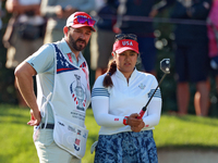 GAINESVILLE, VIRGINIA - SEPTEMBER 14: Lilia Vu of Team USA lines up her putt with her caddie on the 7th green during Day Two of the Solheim...