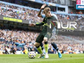 Keane Lewis-Potter #23 of Brentford F.C. is tackled by Savinho #26 of Manchester City F.C. during the Premier League match between Mancheste...