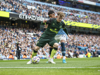 Keane Lewis-Potter #23 of Brentford F.C. is tackled by Savinho #26 of Manchester City F.C. during the Premier League match between Mancheste...