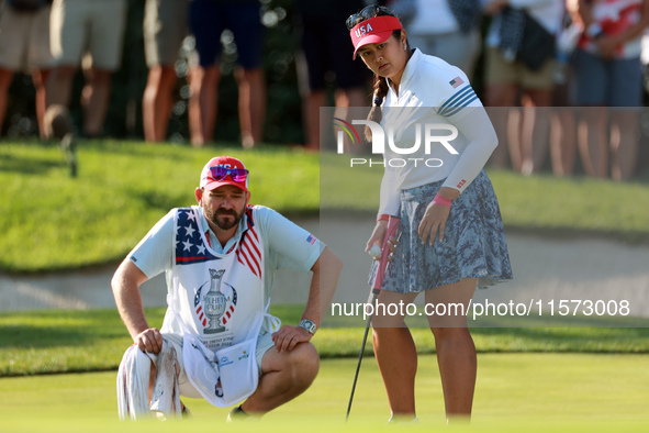 GAINESVILLE, VIRGINIA - SEPTEMBER 14: Lilia Vu of Team USA lines up her putt with her caddie on the 7th green during Day Two of the Solheim...