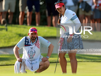 GAINESVILLE, VIRGINIA - SEPTEMBER 14: Lilia Vu of Team USA lines up her putt with her caddie on the 7th green during Day Two of the Solheim...