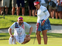 GAINESVILLE, VIRGINIA - SEPTEMBER 14: Lilia Vu of Team USA lines up her putt with her caddie on the 7th green during Day Two of the Solheim...