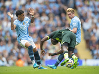 Kevin De Bruyne #17 of Manchester City F.C. tackles the opponent during the Premier League match between Manchester City and Brentford at th...