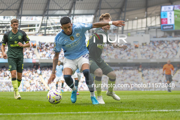 Savinho #26 of Manchester City F.C. is tackled by Keane Lewis-Potter #23 of Brentford F.C. during the Premier League match between Mancheste...