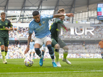 Savinho #26 of Manchester City F.C. is tackled by Keane Lewis-Potter #23 of Brentford F.C. during the Premier League match between Mancheste...