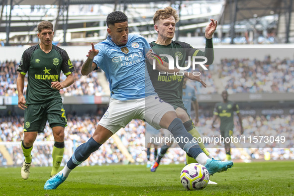 Savinho #26 of Manchester City F.C. is tackled by the opponent during the Premier League match between Manchester City and Brentford at the...