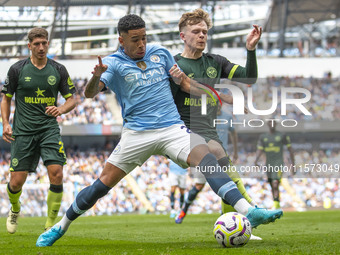 Savinho #26 of Manchester City F.C. is tackled by the opponent during the Premier League match between Manchester City and Brentford at the...