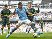 Savinho #26 of Manchester City F.C. is tackled by the opponent during the Premier League match between Manchester City and Brentford at the...