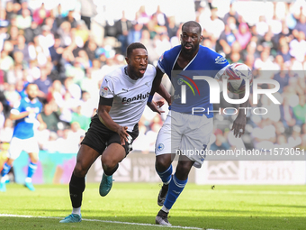 Ebou Adams of Derby County battles with Wilfried Kanga of Cardiff City during the Sky Bet Championship match between Derby County and Cardif...