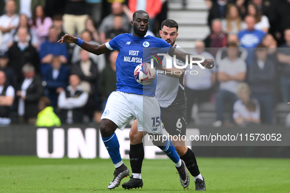 Wilfried Kanga of Cardiff City is under pressure from Eiran Cashin of Derby County during the Sky Bet Championship match between Derby Count...