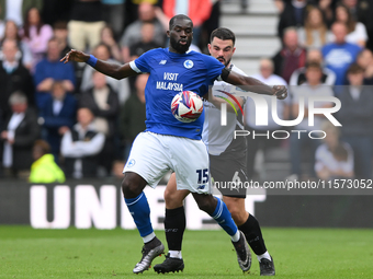 Wilfried Kanga of Cardiff City is under pressure from Eiran Cashin of Derby County during the Sky Bet Championship match between Derby Count...