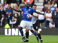 Wilfried Kanga of Cardiff City is under pressure from Eiran Cashin of Derby County during the Sky Bet Championship match between Derby Count...