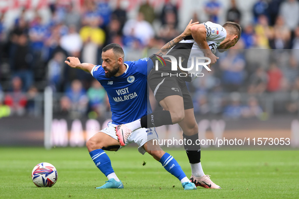 Manolis Siopis of Cardiff City battles with Jerry Yates of Derby County during the Sky Bet Championship match between Derby County and Cardi...