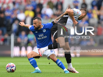 Manolis Siopis of Cardiff City battles with Jerry Yates of Derby County during the Sky Bet Championship match between Derby County and Cardi...