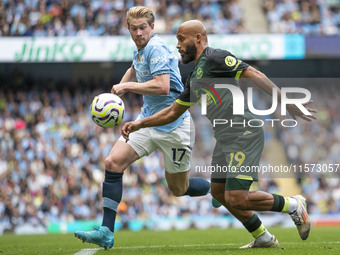 Bryan Mbeumo #19 of Brentford F.C. is tackled by Kevin De Bruyne #17 of Manchester City F.C. during the Premier League match between Manches...