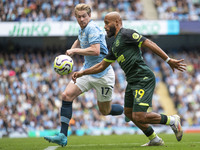 Bryan Mbeumo #19 of Brentford F.C. is tackled by Kevin De Bruyne #17 of Manchester City F.C. during the Premier League match between Manches...