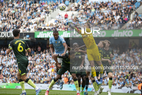 Mark Fleckken #1 (GK) of Brentford F.C. makes a save during the Premier League match between Manchester City and Brentford at the Etihad Sta...