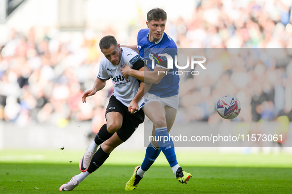 Jerry Yates of Derby County battles with William Fish of Cardiff City during the Sky Bet Championship match between Derby County and Cardiff...