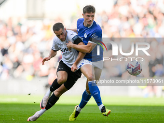 Jerry Yates of Derby County battles with William Fish of Cardiff City during the Sky Bet Championship match between Derby County and Cardiff...