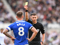 Referee Matthew Donohue shows a yellow card to Joe Ralls of Cardiff City during the Sky Bet Championship match between Derby County and Card...