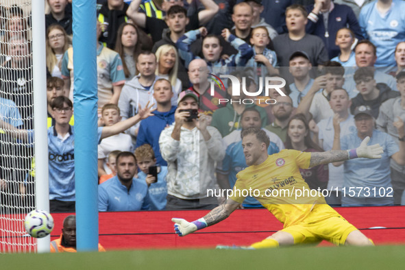 Mark Fleckken #1 (GK) of Brentford F.C. makes a save during the Premier League match between Manchester City and Brentford at the Etihad Sta...