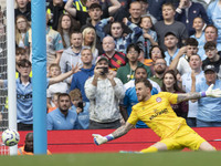 Mark Fleckken #1 (GK) of Brentford F.C. makes a save during the Premier League match between Manchester City and Brentford at the Etihad Sta...