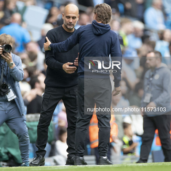 Manchester City F.C. manager Pep Guardiola and Brentford F.C. manager Thomas Franks shake hands at full time during the Premier League match...