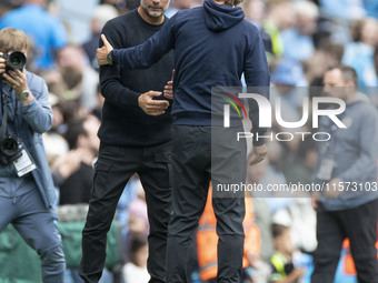 Manchester City F.C. manager Pep Guardiola and Brentford F.C. manager Thomas Franks shake hands at full time during the Premier League match...