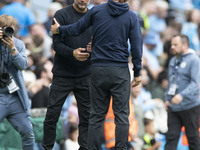 Manchester City F.C. manager Pep Guardiola and Brentford F.C. manager Thomas Franks shake hands at full time during the Premier League match...